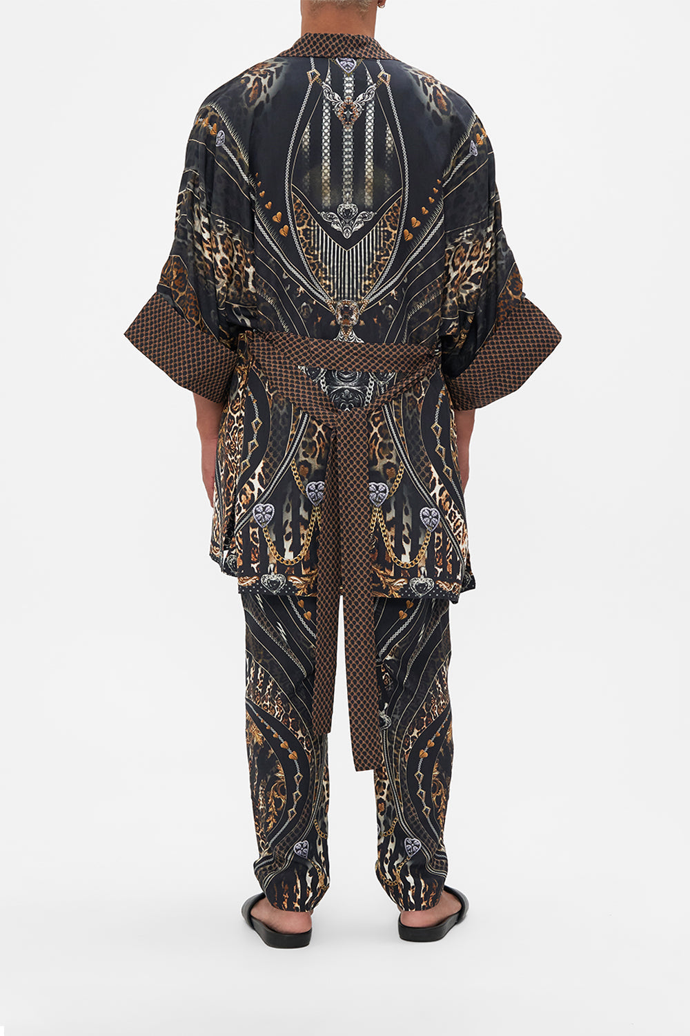 Back view of model wearing Hotel Franks by CAMILLA mens silk robe in Chaos In The Cosmos animal print