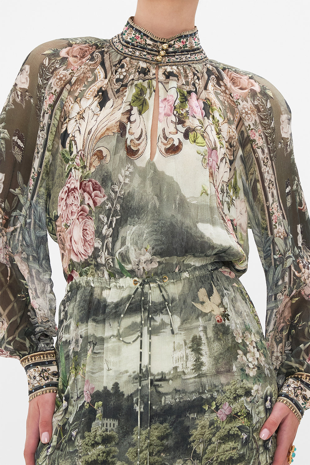 Detail view of model wearing CAMILLA green silk floral maxi dress in Garden Of Good Fortune print