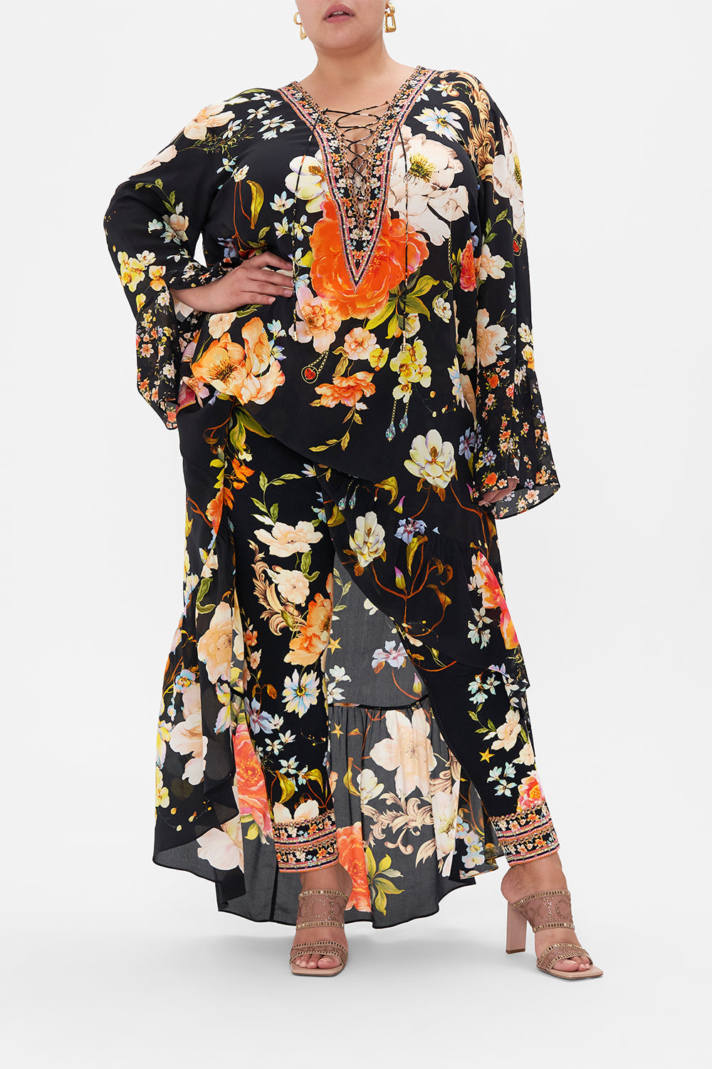 Front view of curvy model wearing CAMILLA plus size floral print leggings in Secret History print