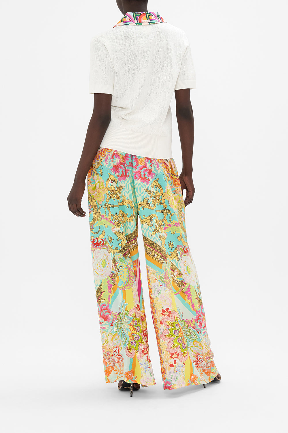 Back view of model wearing CAMILLA white knit polo top in An Italian Welcome print