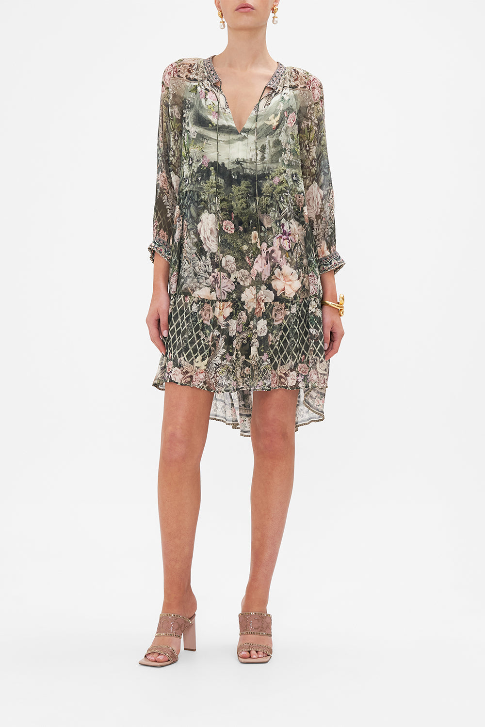Front view of model wearing CAMILLA green floral mini dress in Garden Of Good Fortune print