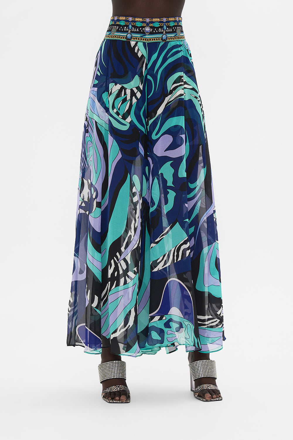 Crop view of model wearing CAMILLA sheer silk palazzo pants in Vividly Venice print