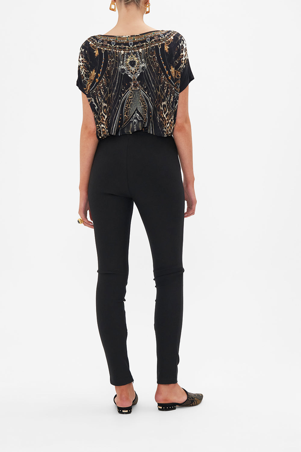 Back view of model wearing CAMILLA black ponte pants in Chaos In The Cosmos