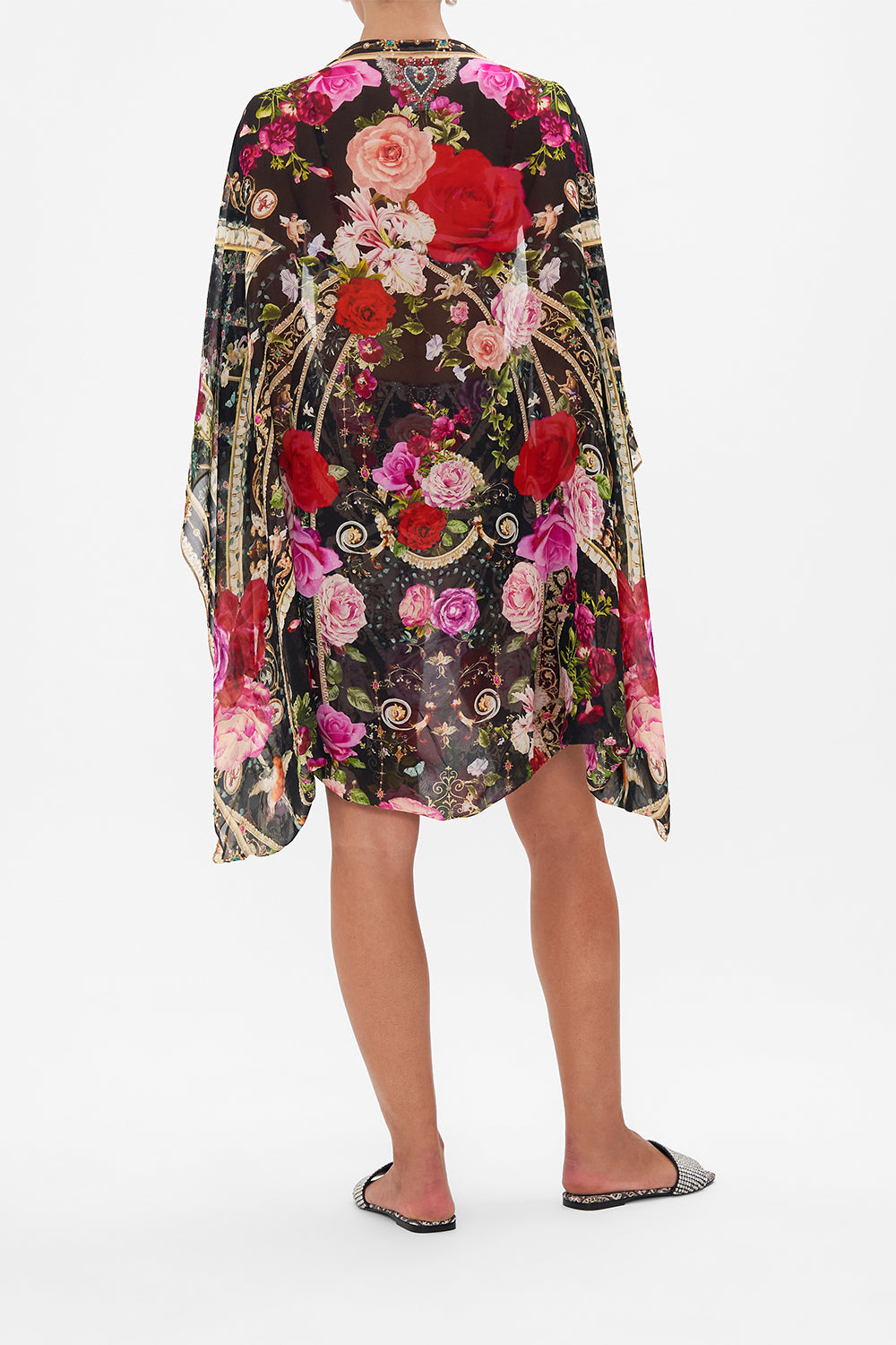 Back view of model wearing CAMILLA floral silk shrug in Reservation for Love print