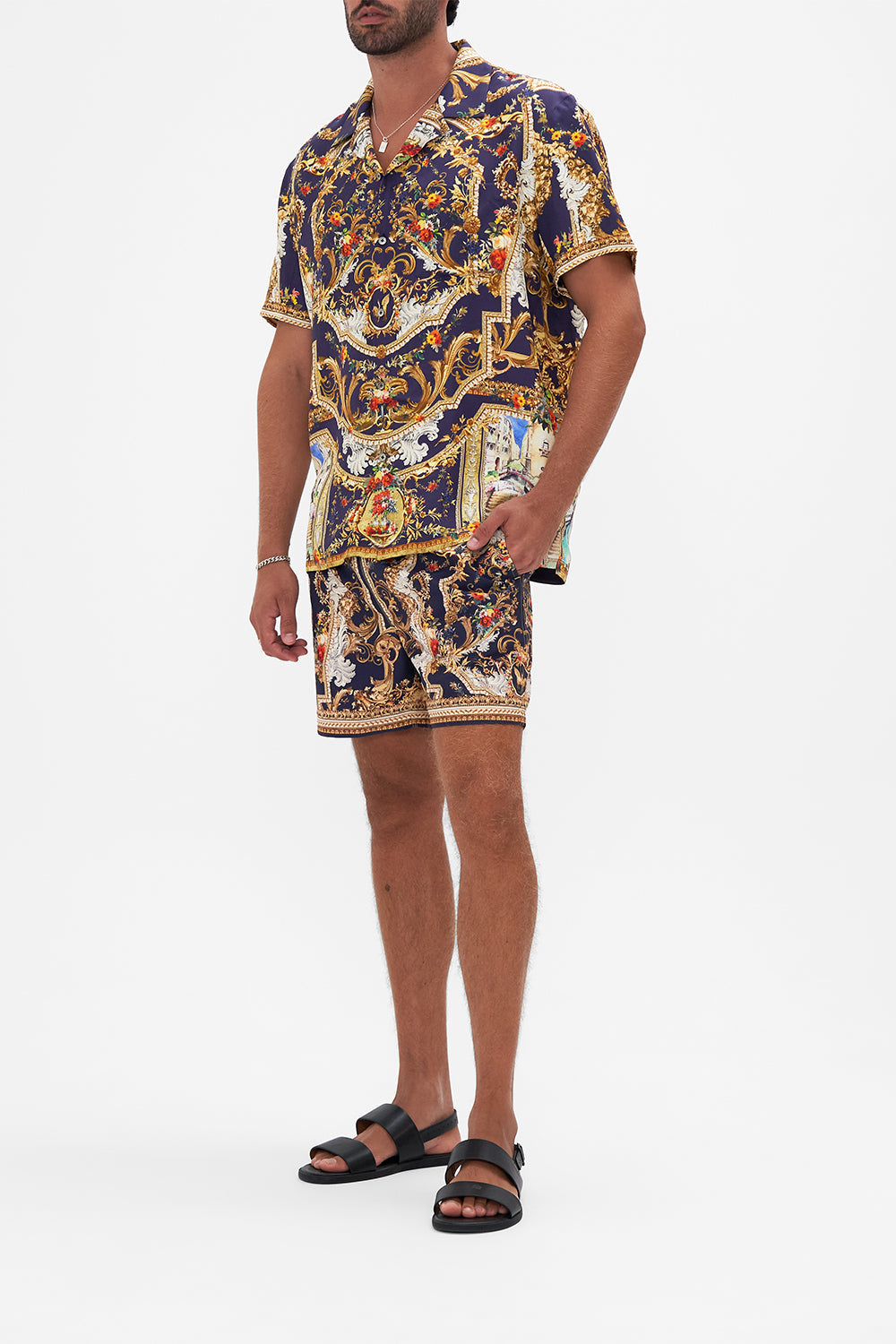 Side view of model wearing Hotel Franks By CAMILLA mens short sleeve camp collared shirt in Venice Vignette print