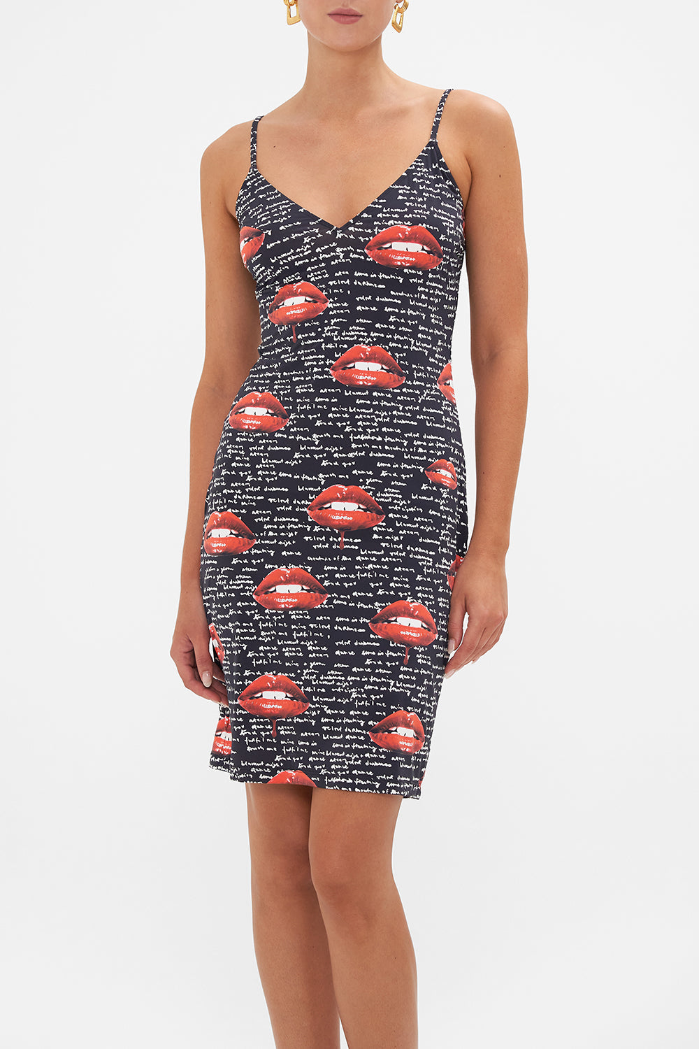 Crop view of model wearing CAMILLA black slip dress in Chaos Magic print