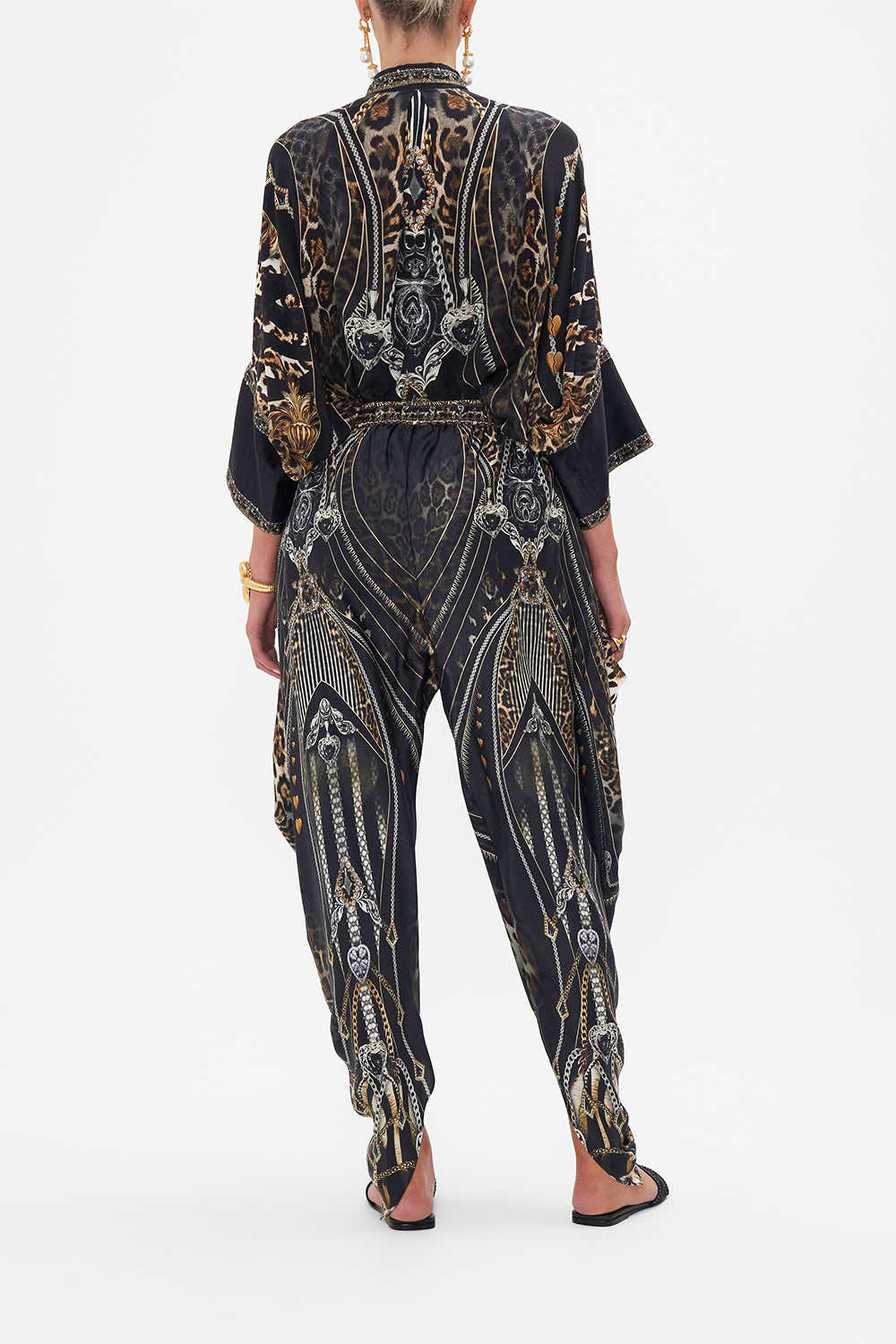 Back view of model wearing CAMILLA drapey silk pants in Chaos In The Cosmos animal print