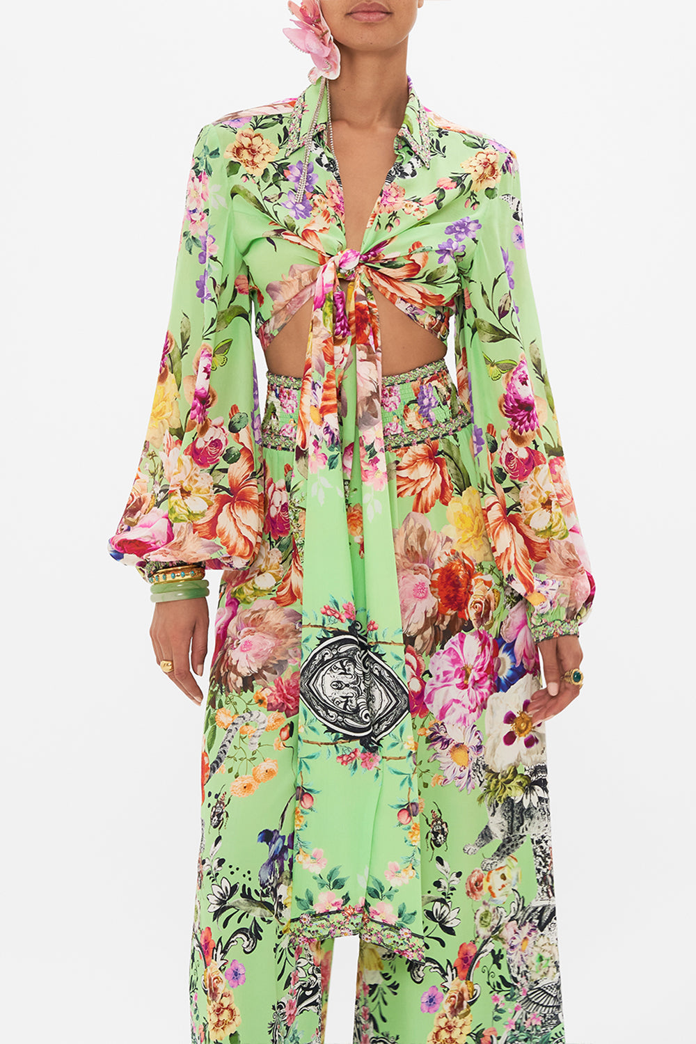 Crop view of model wearing CAMILLA wrap shirt in Porcelain Dream print