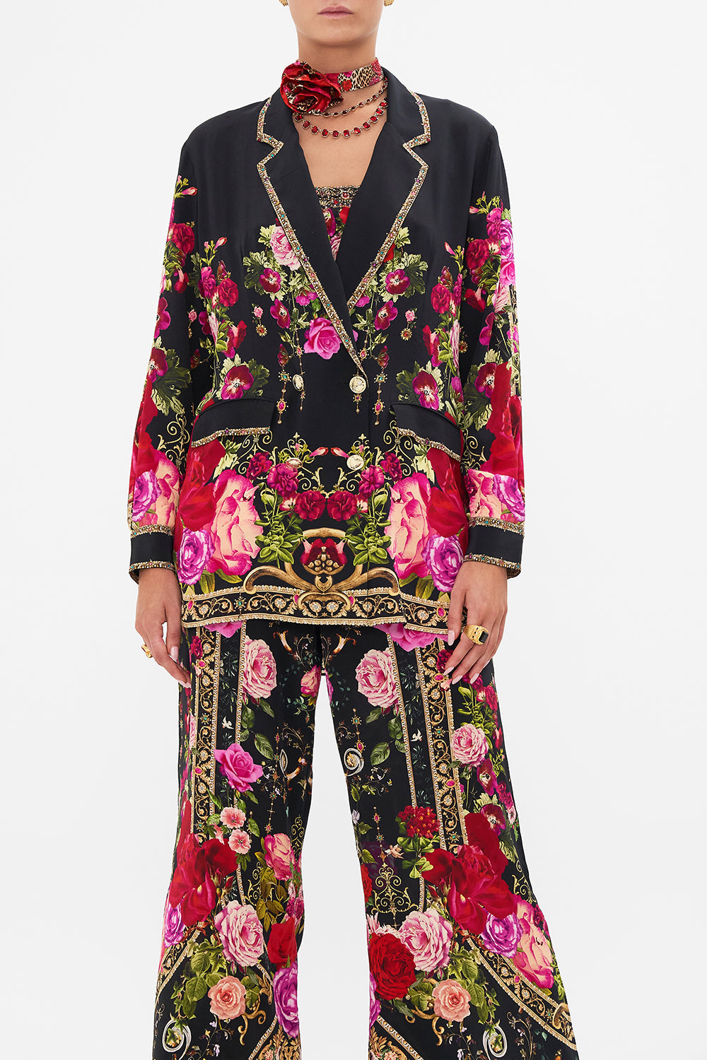 Crop view of model wearing CAMILLA silk jacket in Reservation For Love print