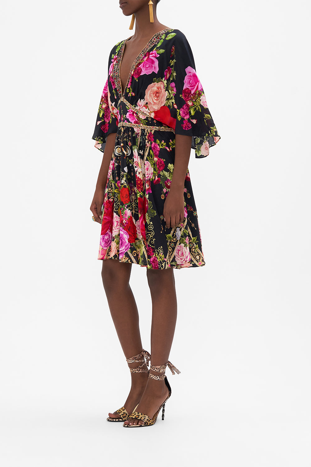 Side view of model wearing CAMILLAdesigner mini dress in Reservation for Love print