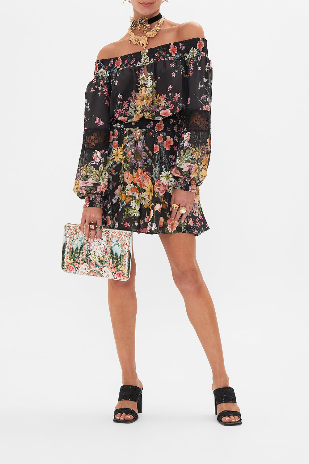 Front view of model wearing CAMILLA off the shoulder mini dress in Letters From A Vineyard print