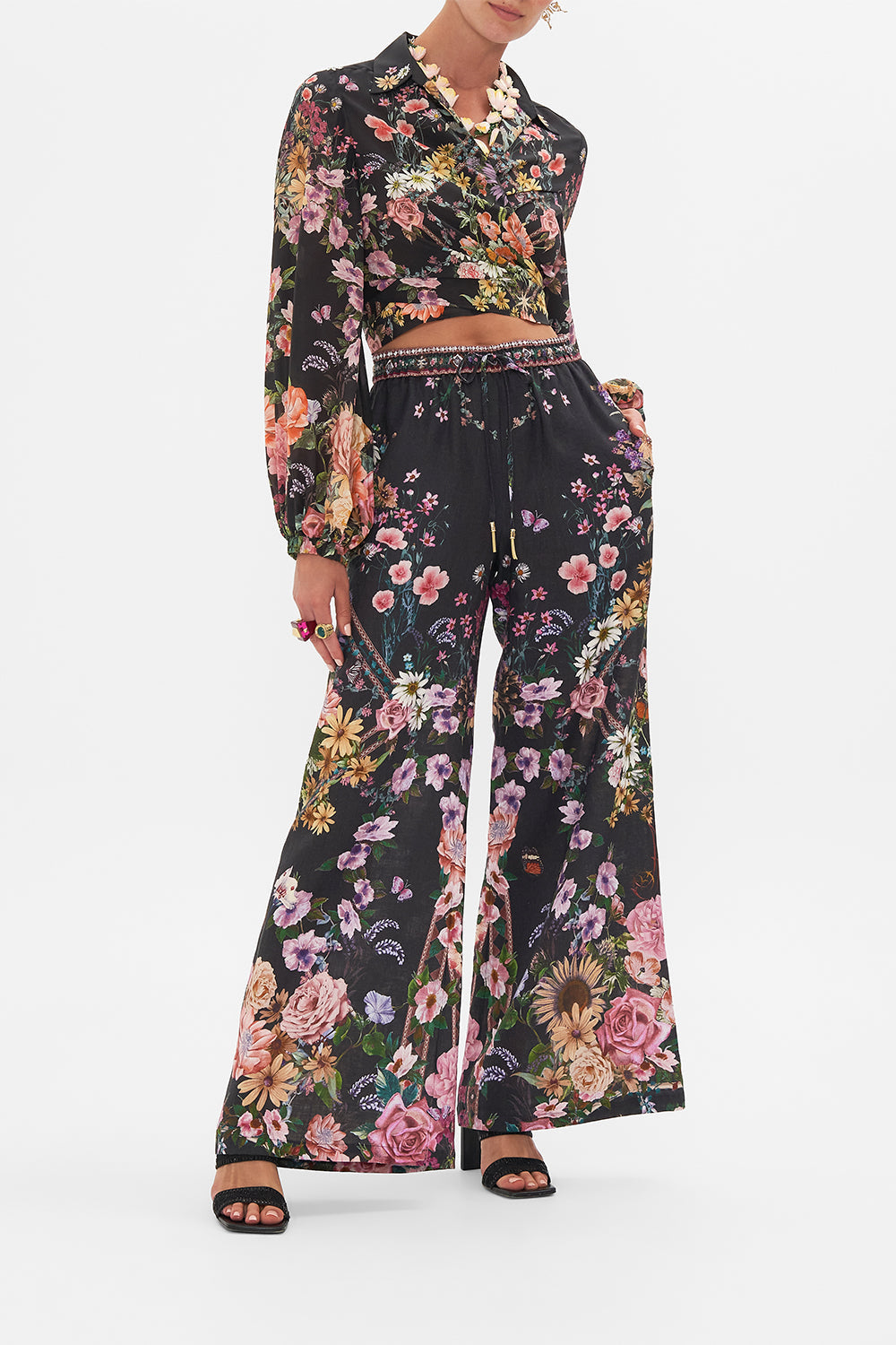 Front view of model wearing CAMILLA linen lounge pant in Letters From A Vineyard print