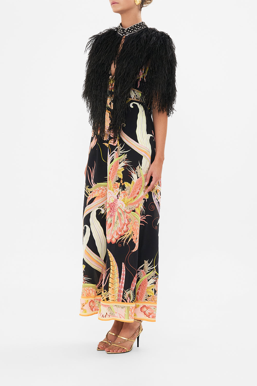 Side view of model wearing CAMILLA beaded feather gilet in Lady of The Moon print