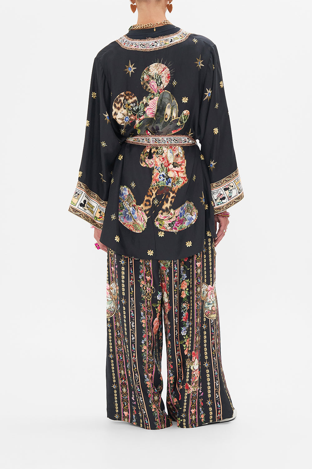 Back view of model wearing Disney x CAMILLA short silk kimono at Midnght At Minnies print