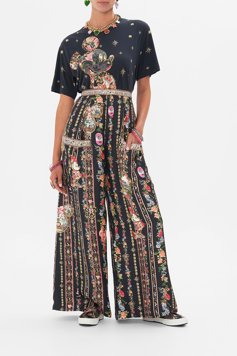Front view of model wearing Disney x CAMILLA silk pants in Midnight At Minnies print