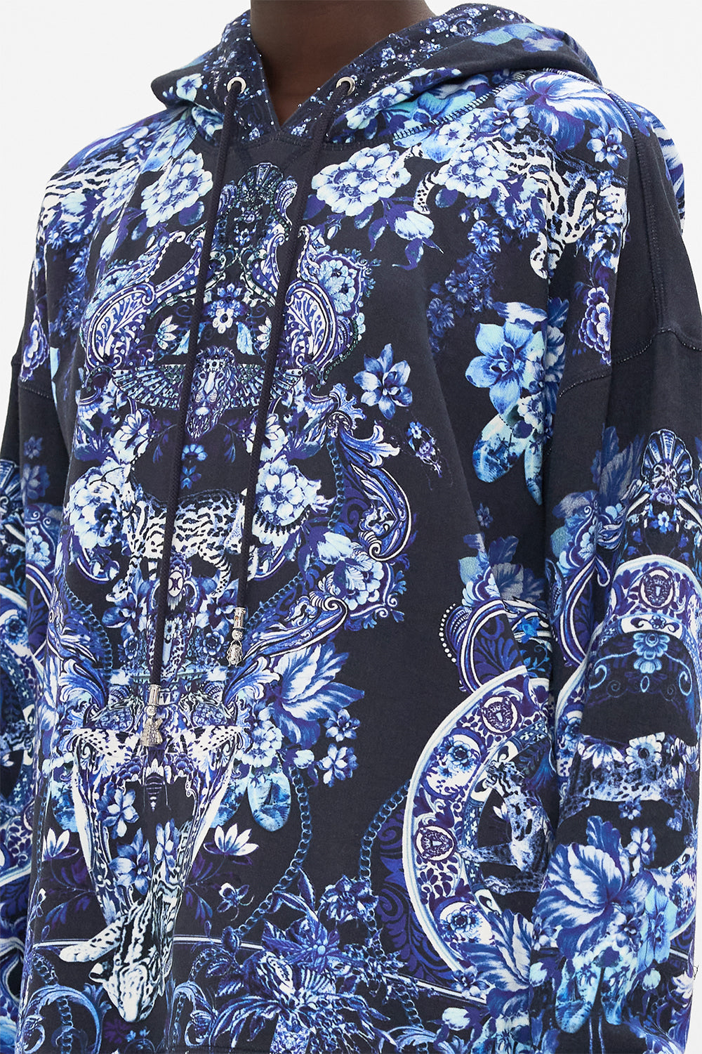 Detail view of model wearing CAMILLA printed hoodie in Delft Dynasty print