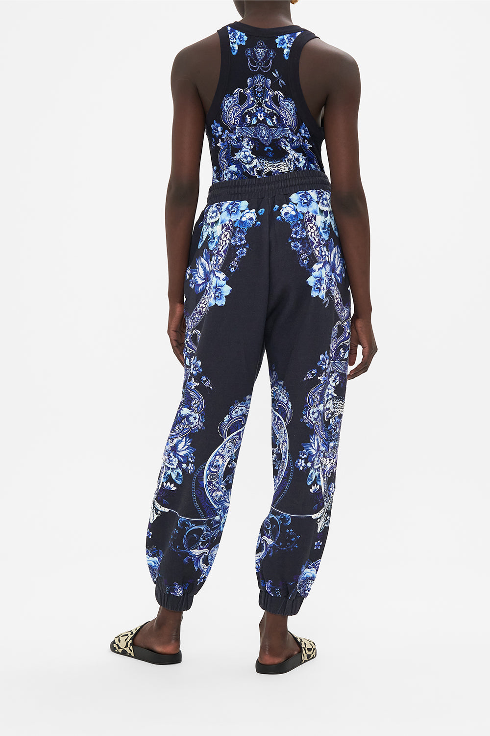 Back view of model wearing CAMILLA designer track pants in Delft Dynasty print 