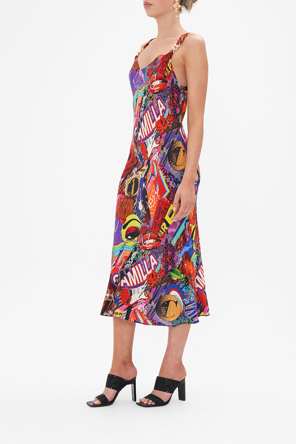 Side view of model wearing CAMILLA bias silk slip dress in multicoloured Radical Rebirth print