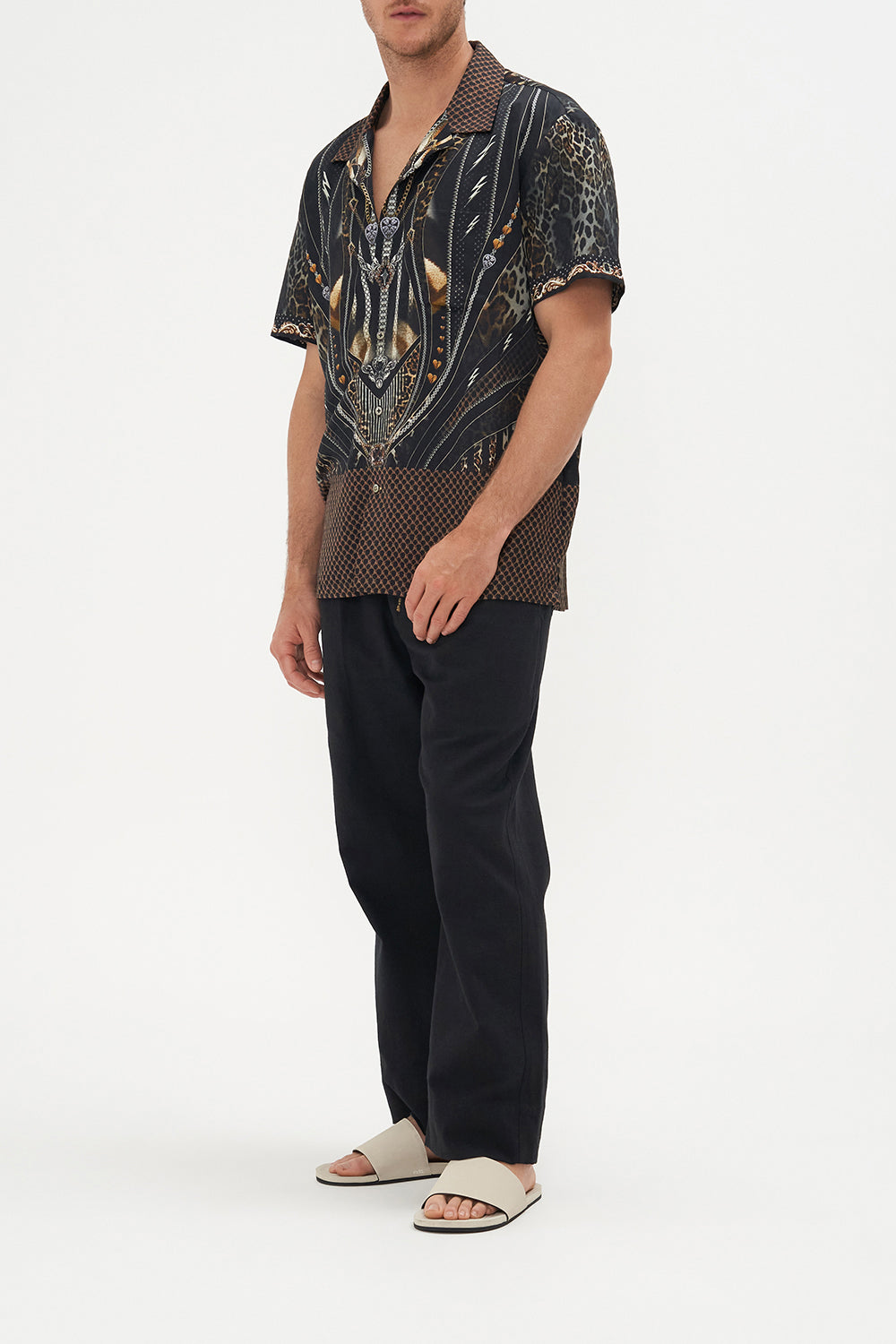 Side view of model wearing Hotel Franks by CAMILLA mens short sleeve camp collar shirt in Chaos in The Cosmos animal print 