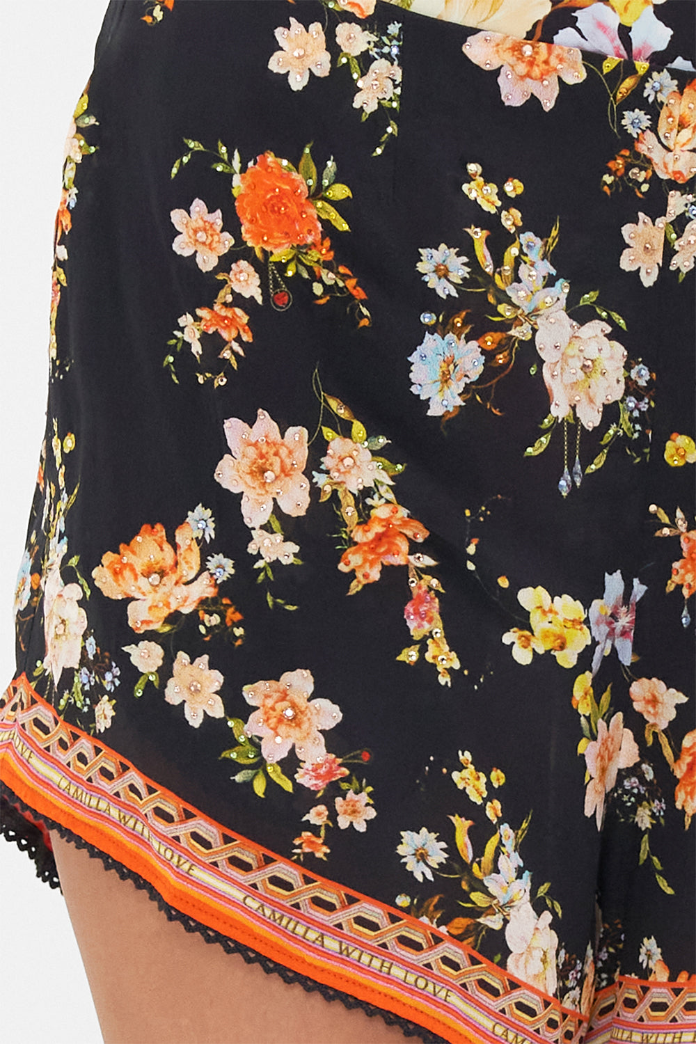 Detail view of model wearing CAMILLA floral silk shorts in Secret History print