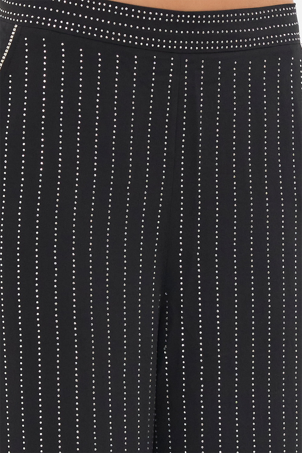 Detail view of model wearing CAMILLA floral silk pants in Curtain Call Chaos print