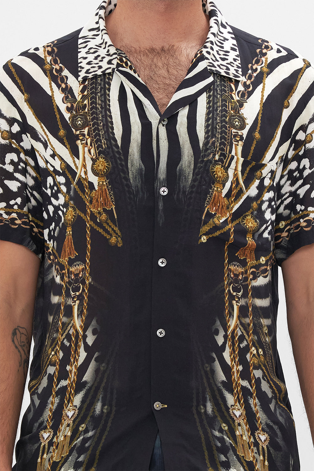 Detail view of model wearing Hotel Franks by CAMILLA mens black and white short sleeve button through shirt in Untamed Royalty print