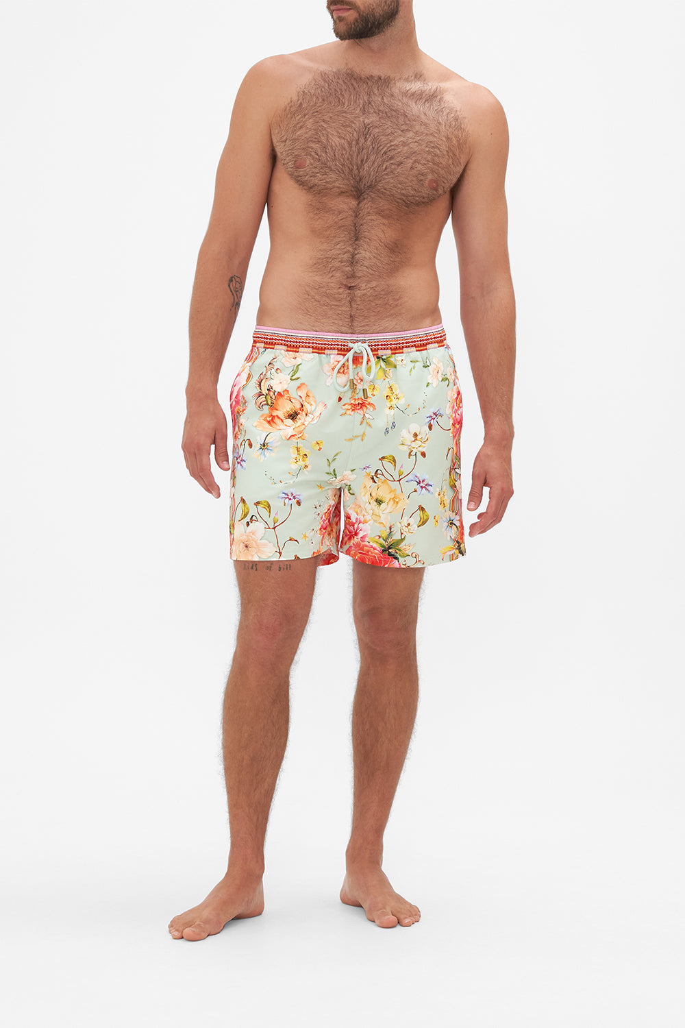 Front view of model wearing Hotel Franks by CAMILLA mens floral print boardshorts in Talk The Walk print