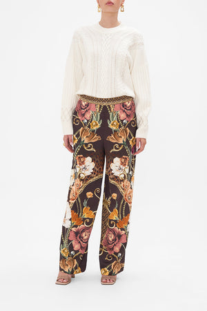 Front view of model wearing CAMILLA floral silk pants in Wave Your Wand print