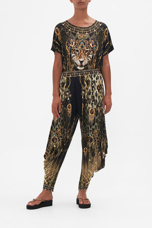 Front view of model wearing CAMILLA jersey drape pants in Lions Mane print