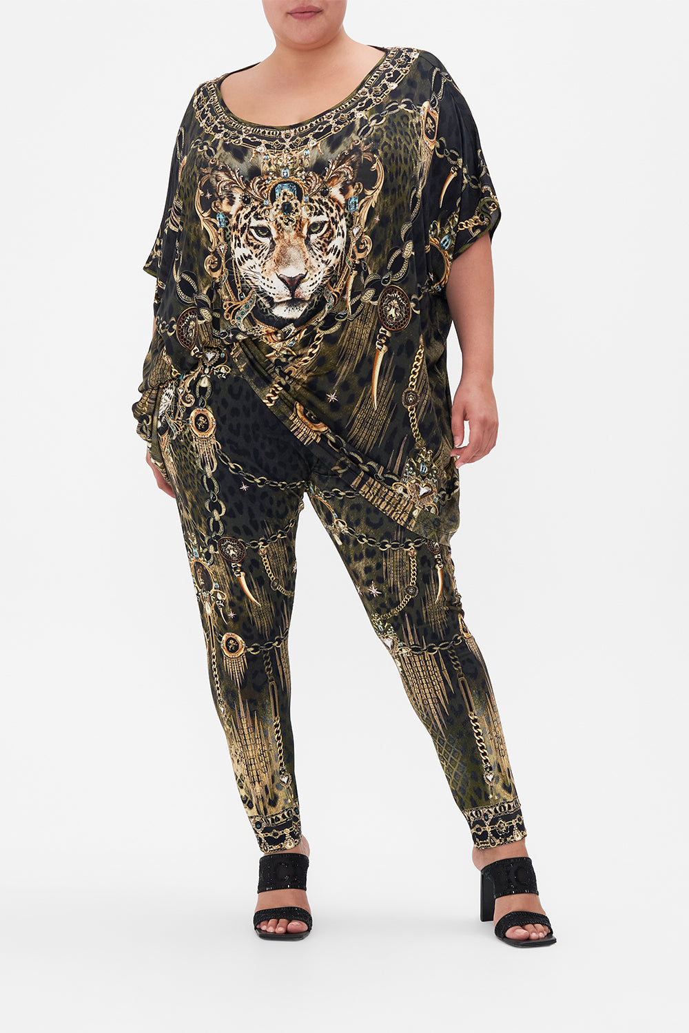 Front view of curvy model wearing CAMILLA Plus size animal print leggings in Lions Mane print