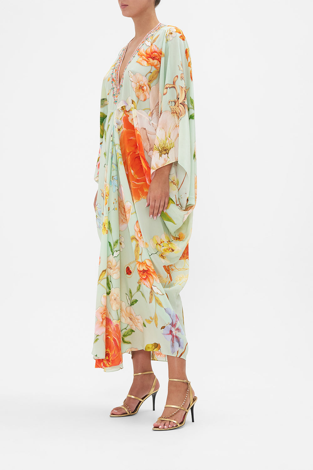 Side view of model wearing CAMILLA floral silk kaftan in Talk The Walk print 