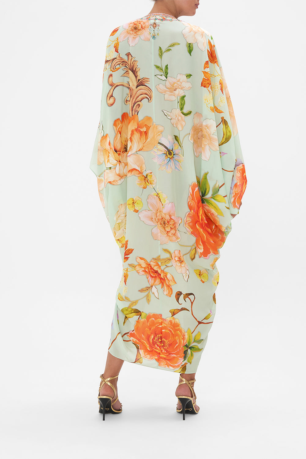 Back view of model wearing CAMILLA floral silk kaftan in Talk The Walk print 