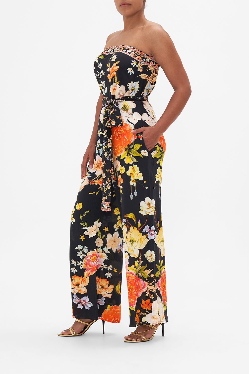 Side view of model wearing CAMILLA strapless floral silk jumpsuit in Secret History print
