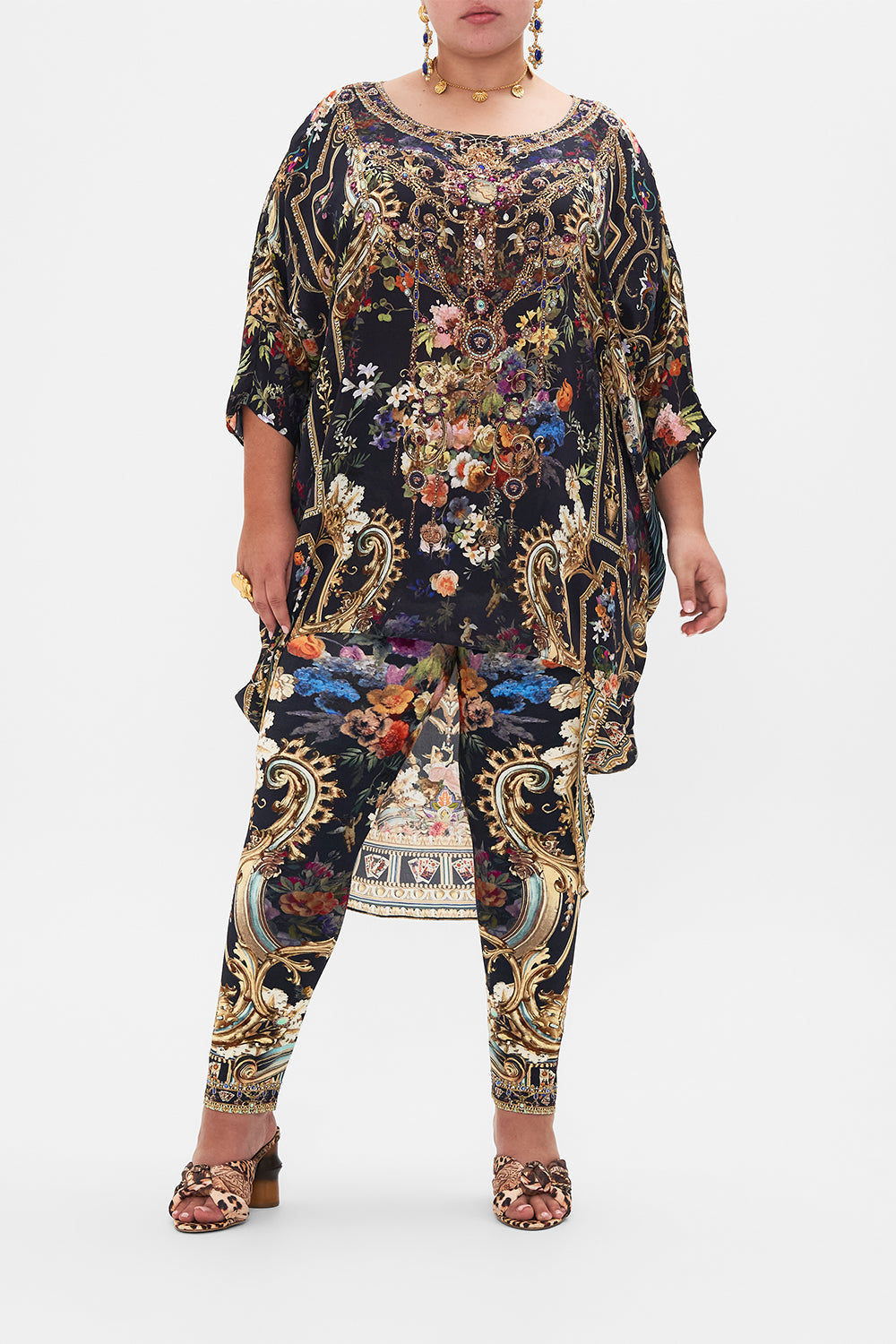 Front view of curvy model wearing CAMILLA plus size  floral leggings in Play Your Cards Right print