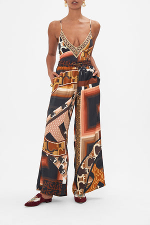Front view of model wearing CAMILLA brown silk pants in Feeling Fresco print