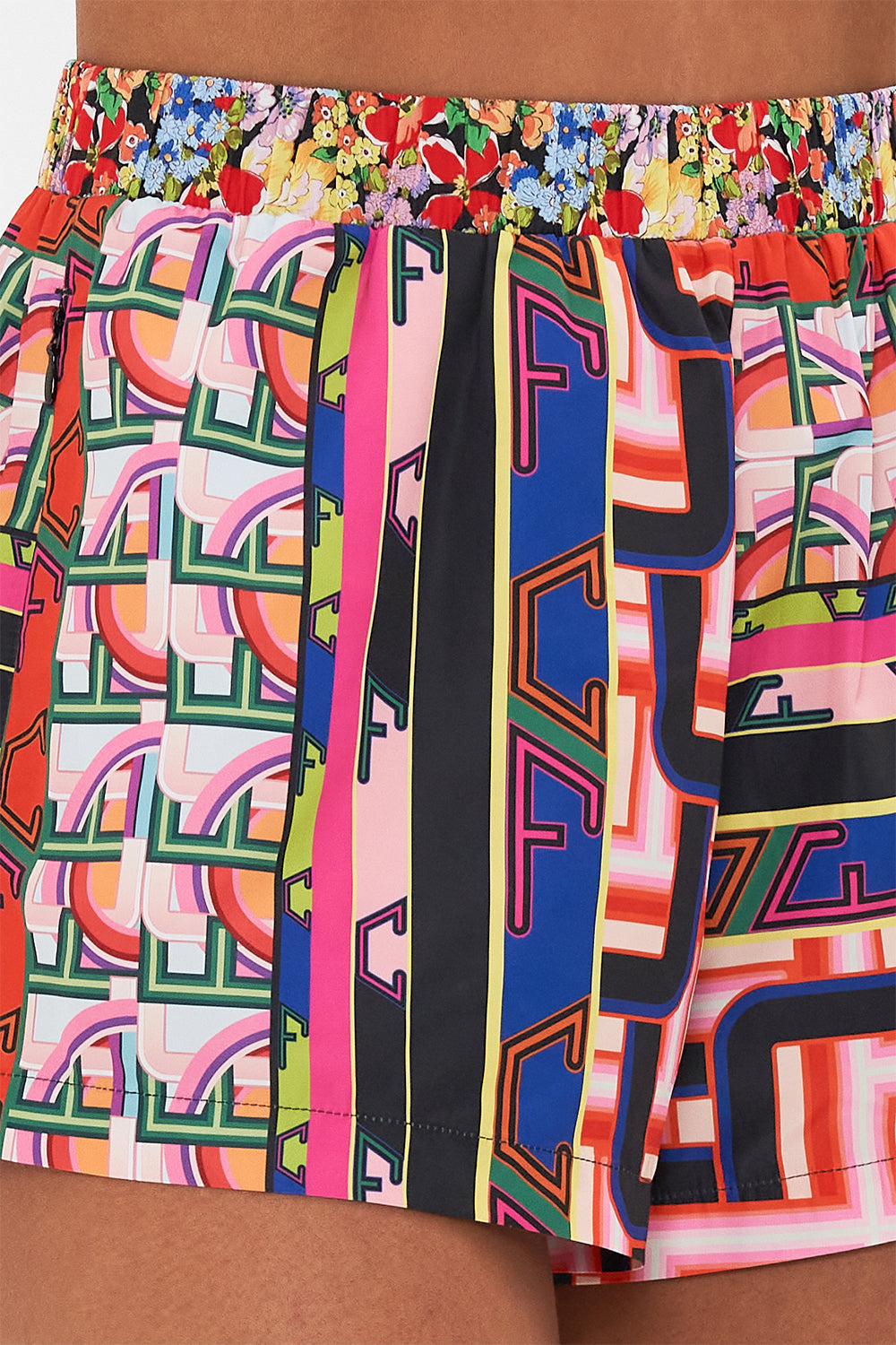 Detail view of  model wearing CAMILLA printed running short in Ciao Bella print