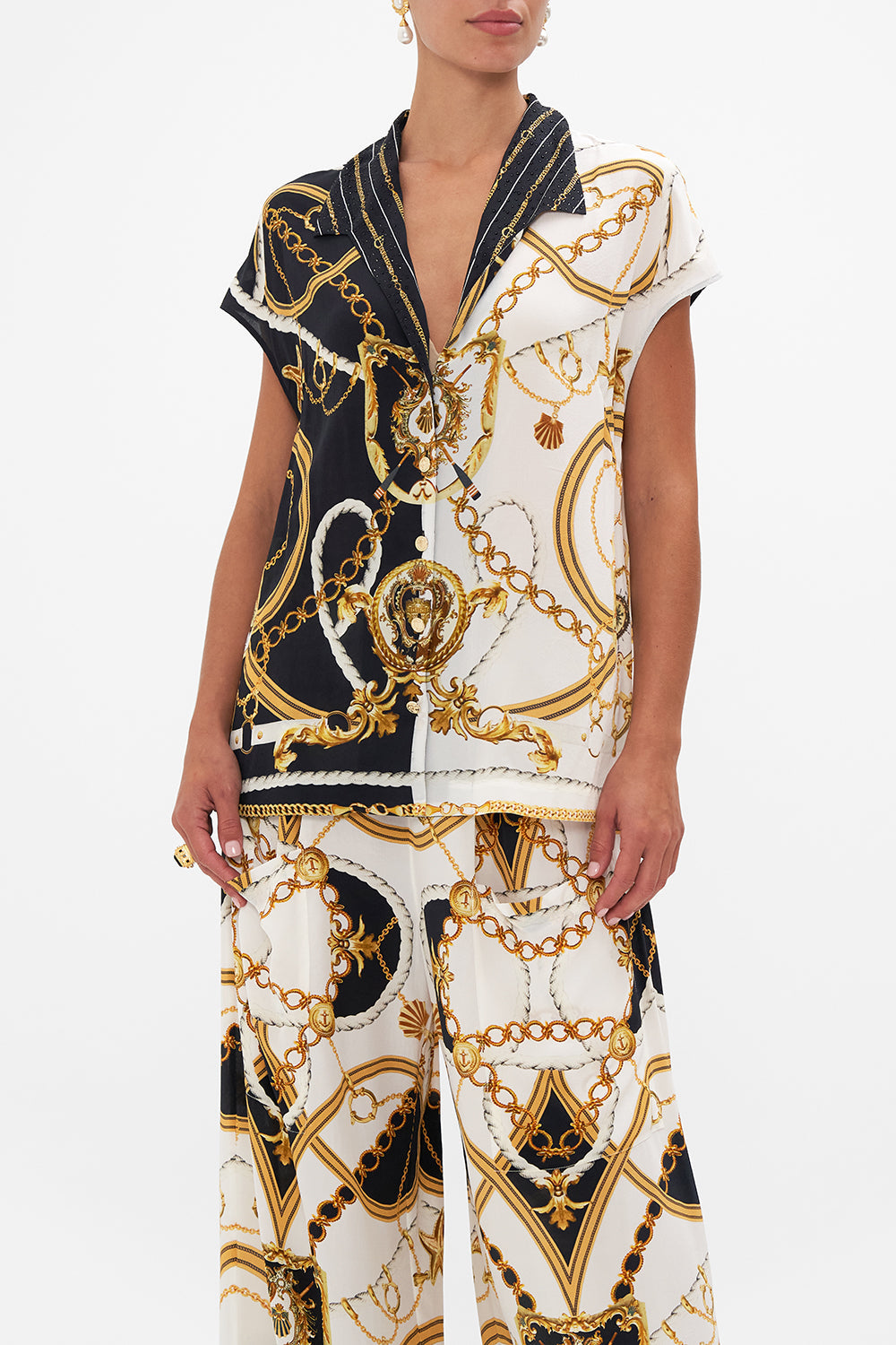 Crop view of model wearing silk shirt in Coast To Coast print 