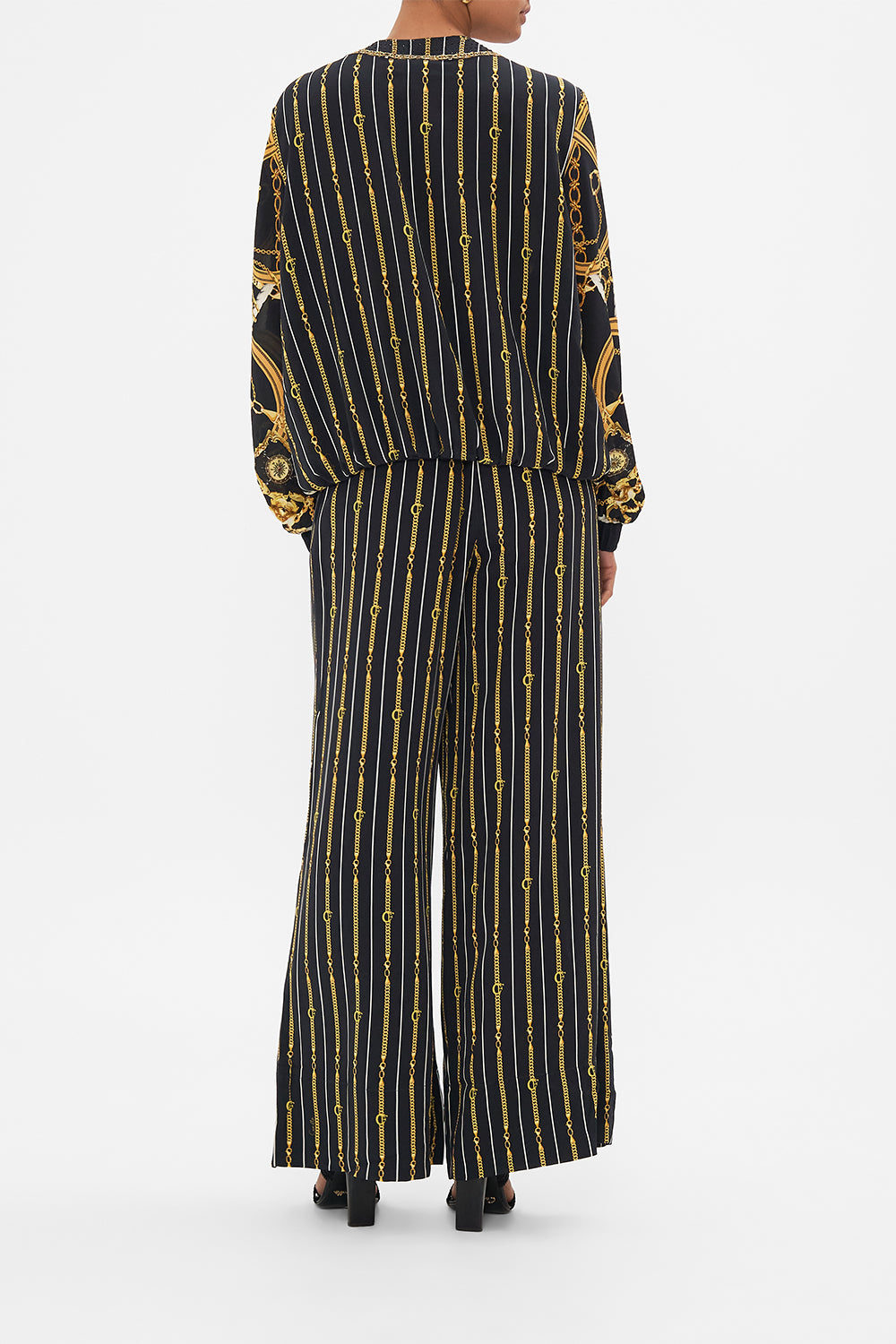 Back view of model wearing CAMILA silk bomber jacket in Coast to Coast print