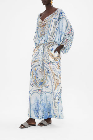 Side view of model wearing CAMILLA silk blouse in Season Of the Siren print