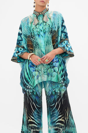 Crop view of model wearing CAMILLA silk shirt in Azure Allure print 