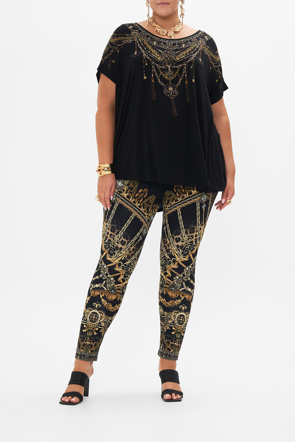 Front view of cove model wearing CAMILLA plus size black t shirt in Masked At Moonlight print