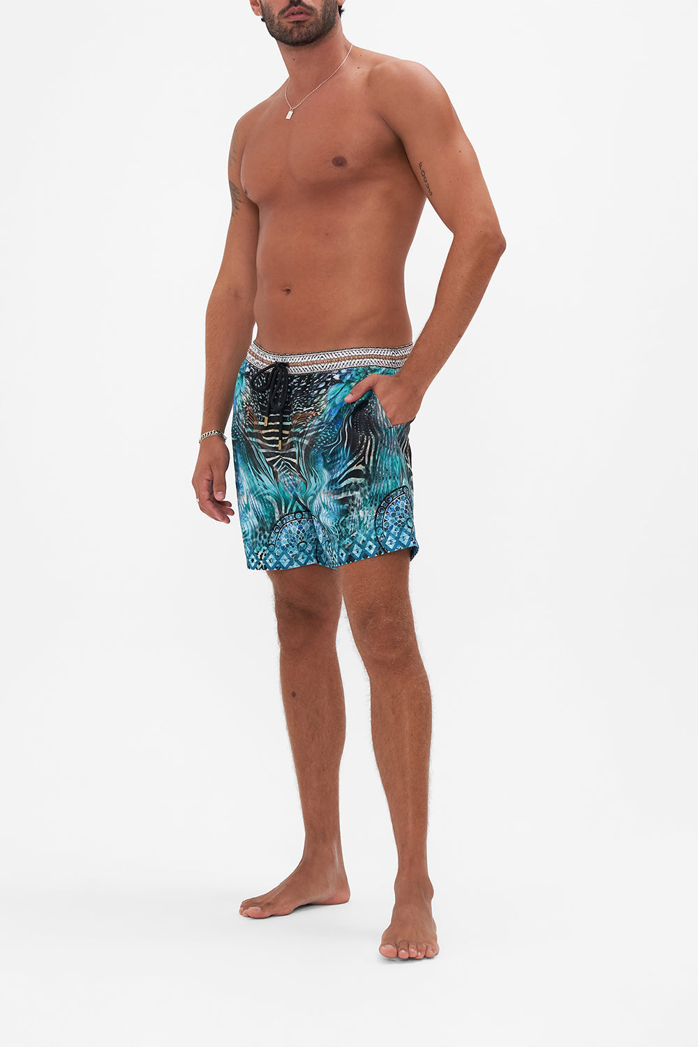 Side view of model wearing Hotel Franks By CAMILLA luxury mens boardshorts in Azure Allure