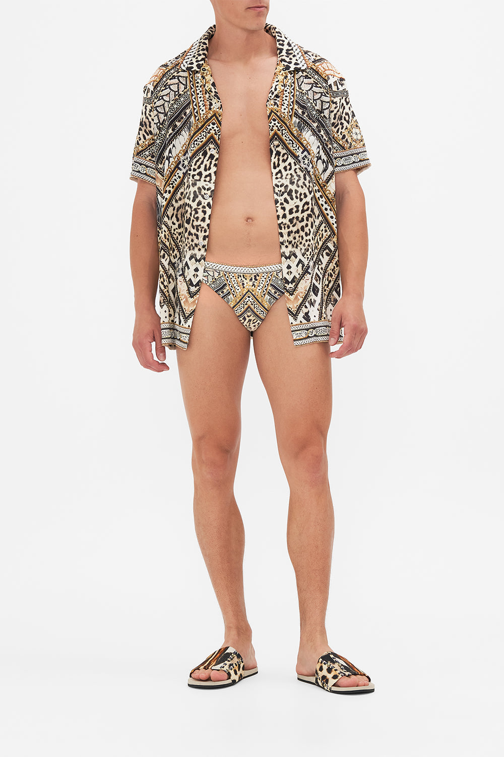 Front view of model wearing Hotel Franks By CAMILLA  mens swim breif in Mosiac Muse print 