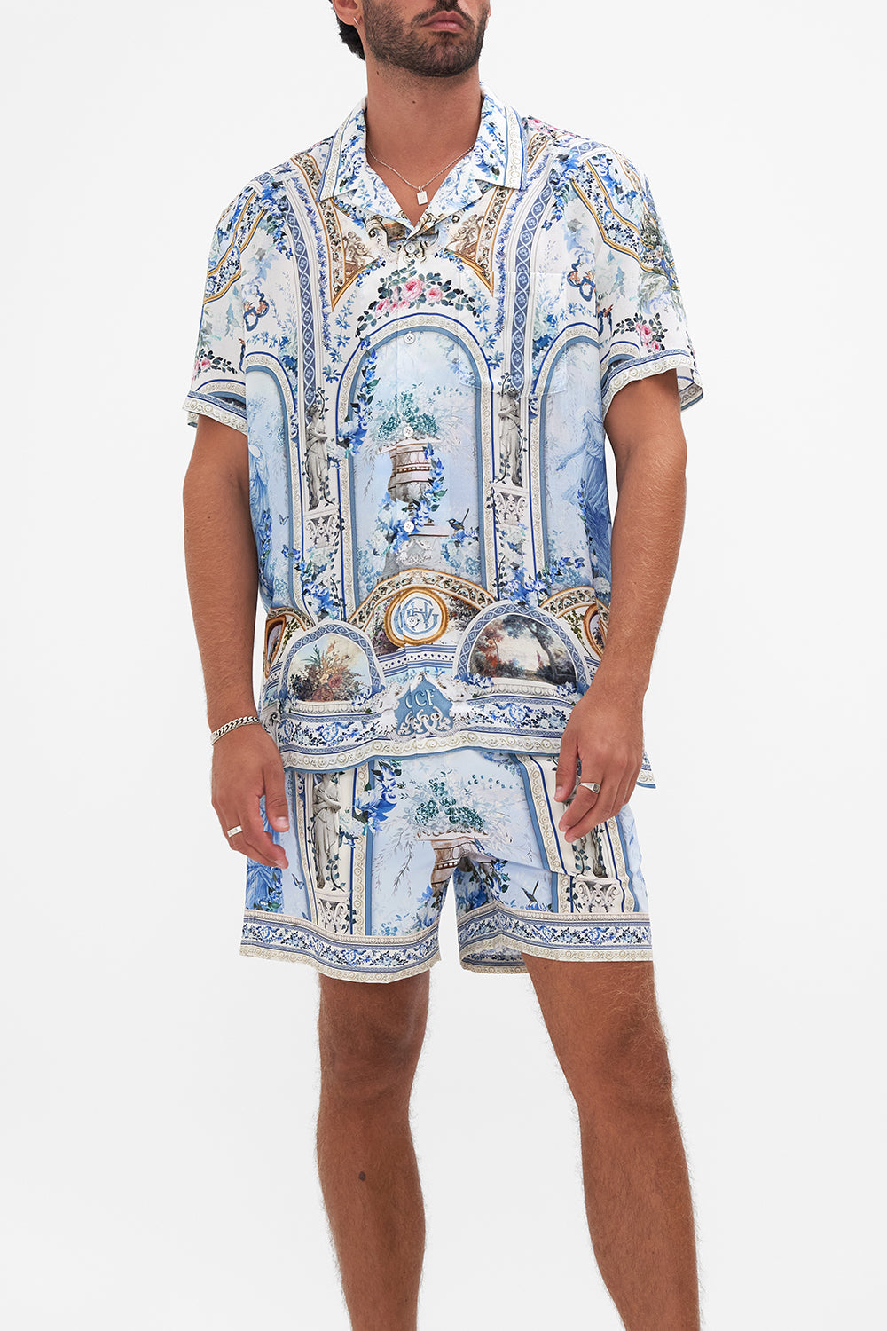 Crop view of model wearing HOTEL FRANKS BY CAMILLA collared shirt in Season of the Siren print