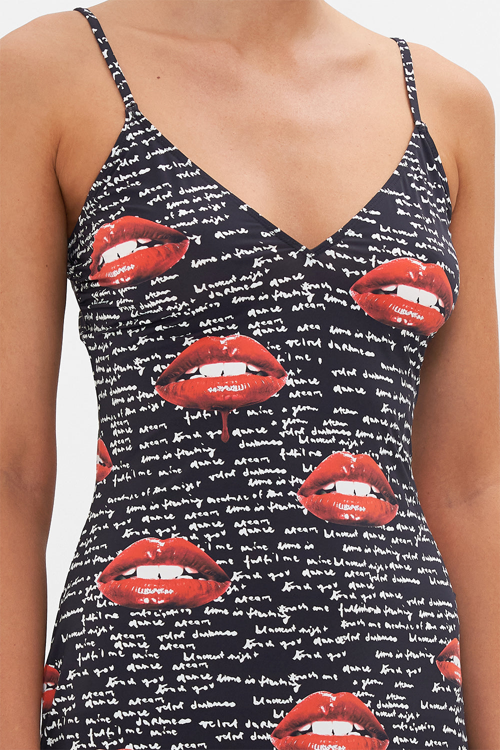 Detail view of model wearing CAMILLA black slip dress in Chaos Magic print 