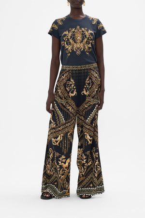 Front view of model wearing CAMILLA silk  pants in Duomo Dynasty print