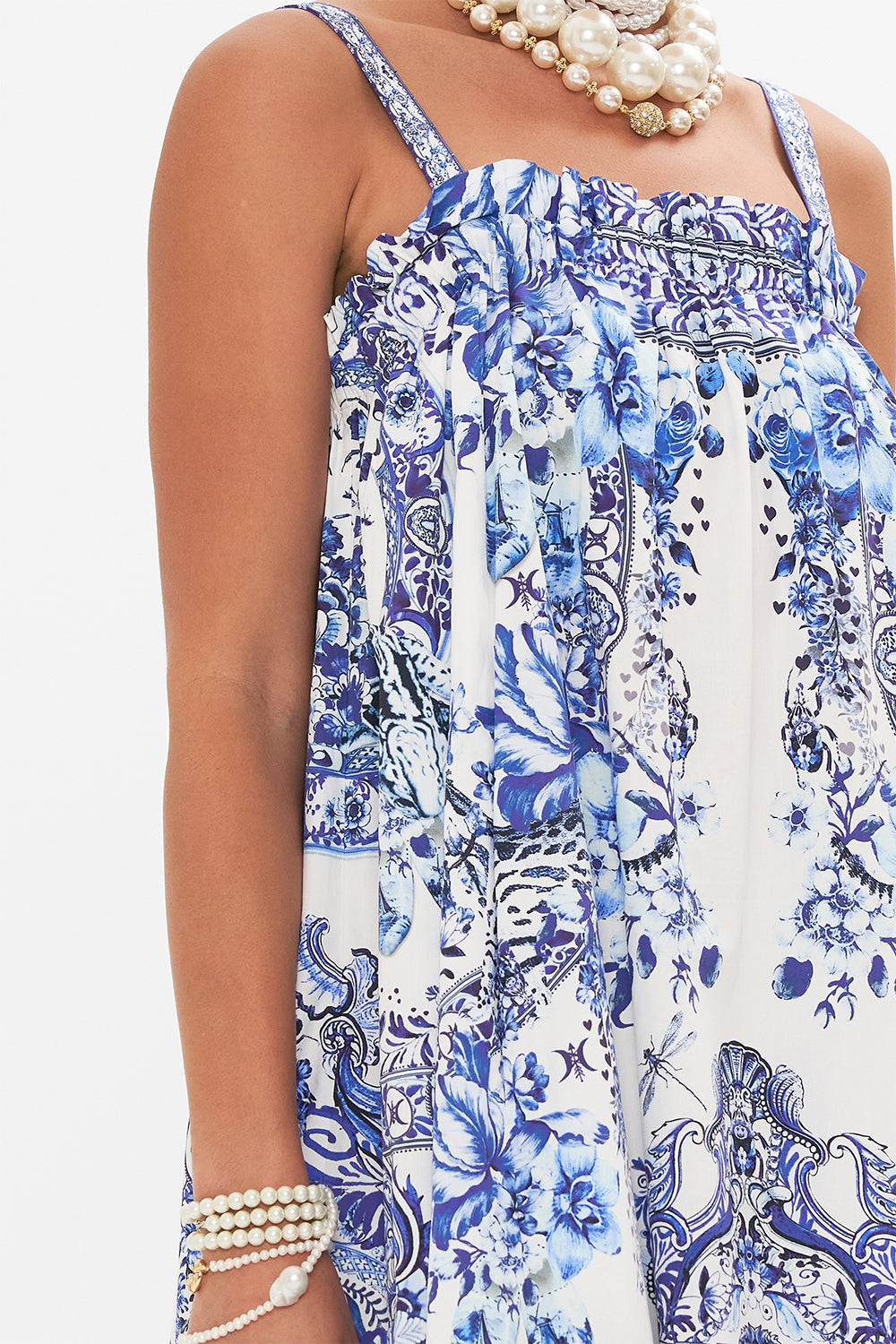 Detail view of model wearing CAMILLA blue and white  sun dress in Glaze and Graze print 