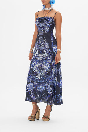 Side view of model wearing CAMILLA silk dress in Delft Dynasty print