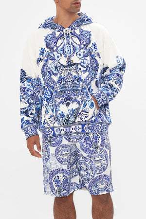 Crop view of model wearing Hotel Franks by CAMILLA mens oversized hoodie in Glaze and Graze print