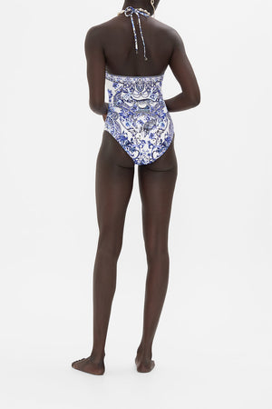 Back view of model wearing CAMILLA blue and white womens swimsuit in Glaze and Graze print 